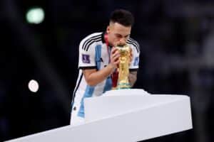 LUSAIL CITY, QATAR - DECEMBER 18: Lautaro Martinez of Argentina kisses the FIFA World Cup winning trophy during the award ceremony following the FIFA World Cup Qatar 2022 Final match between Argentina and France at Lusail Stadium on December 18, 2022 in Lusail City, Qatar. (Photo by Clive Brunskill/Getty Images)