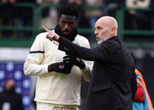 AC Milan's Italian head coach Stefano Pioli (R) talks with AC Milan's French midfielder Tiemoue Bakayoko during the warm up prior to the Serie A football match beetween Venezia and AC Milan at the Pier Luigi Penso stadium in Venice on January 9, 2022. (Photo by Marco BERTORELLO / AFP) (Photo by MARCO BERTORELLO/AFP via Getty Images)
